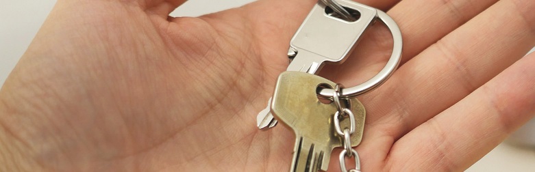 Hand holding key to the door
